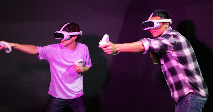 Two men engaged in an immersive VR gaming experience