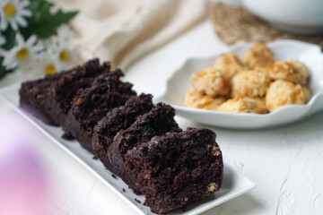 Chocolate moist cake with nuts and cornflakes cookies.