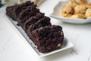 Chocolate moist cake with nuts and cornflakes cookies.