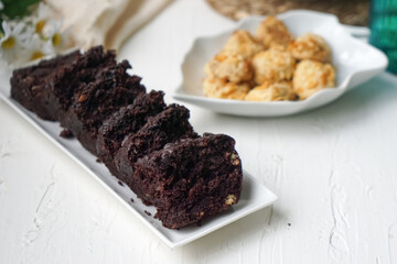 Chocolate moist cake with nuts and cornflakes cookies.