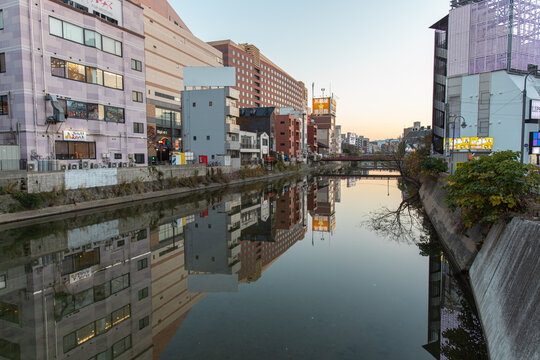 Fukuoka, JAPAN - Dec 6 2021 : A view of Nakasu in the evening. Naka River (Naka-gawa) and buildings can be seen in the image.
