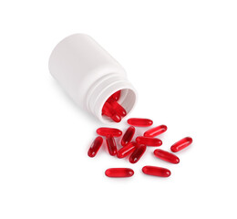 Plastic medical bottle with many red pills isolated on white