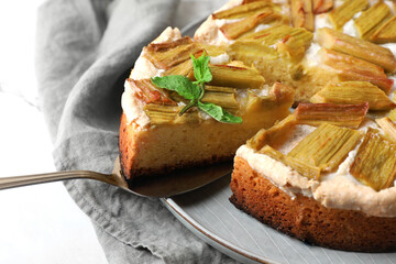 Freshly baked rhubarb pie and spatula on white table, closeup