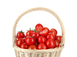 Wicker basket with fresh ripe cherry tomatoes isolated on white