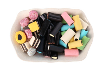Tray with many tasty liquorice candies isolated on white, top view