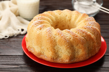 Delicious freshly baked sponge cake on wooden table, closeup