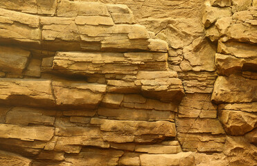 Light coarse natural rock stone background. Mining cliff rough front surface. Big limestone stack backdrop. Heavy grunge damaged granite block texture. Crack antique medieval stony facade for design