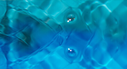 Blue water with ripples on the surface. Defocus blurred transparent white-black colored clear calm...