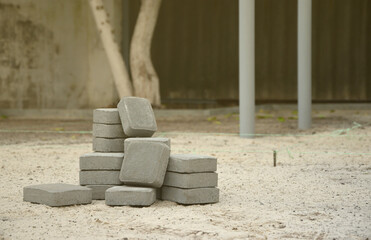 Small pile of gray walkway slabs lying in stack outdoors. Material for Paving Slabs by mosaic in...