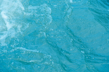 Blue water with ripples on the surface. Defocus blurred transparent white-black colored clear calm...