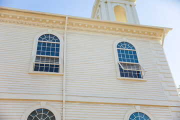 church facade with intricate architecture, towering spire, and vibrant stained glass windows...