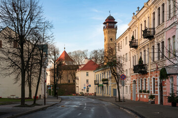 Fototapeta na wymiar View of an old street in the historical center of the city and a fire tower in the background, Grodno, Belarus