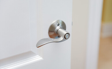 metallic door handle hand, symbolizing opportunity, access, and welcoming invitation in architectural design