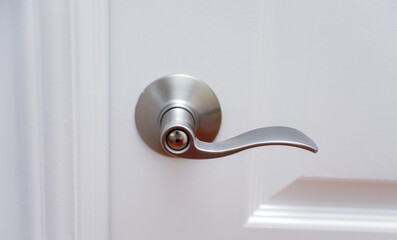 metallic door handle hand, symbolizing opportunity, access, and welcoming invitation in architectural design