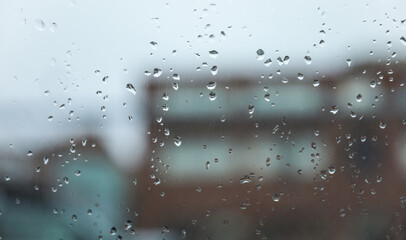 Raindrops adorn windowpane, creating a melancholic ambiance, symbolizing solitude, introspection,...