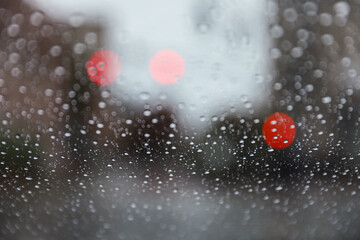 Raindrops adorn windowpane, creating a melancholic ambiance, symbolizing solitude, introspection,...