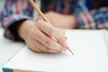 Asian teenage student write homework, study lesson for exam online learning education.