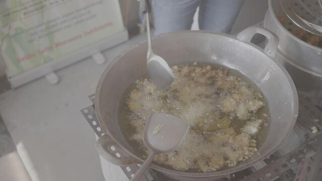 (V-Log) Cooking Deep Frying Meatballs in a large Frying Pan