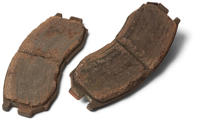 pair of old worn out car disc brake pads, components of vehicle braking system, made of friction...