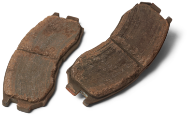 pair of old worn out car disc brake pads, components of vehicle braking system, made of friction materials that grip brake disc or rotor isolated on white background, vehicle maintenance and repair
