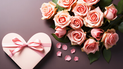 Bouquet of pink roses with a gift box in the shape of a heart. Space for text.