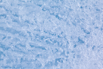 Texture of winter ice surface. Blue natural ice background