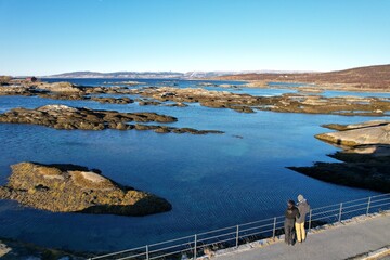 Quiet observers take in the sprawling view of a Norwegian archipelago