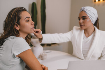 Esthetician doctor evaluating the facial touch-ups of a patient