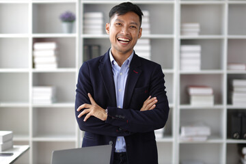 Portrait of a young businessman working happily in the office.
