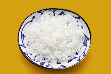 Cooked rice on yellow background.