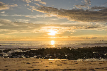 Golden Sunset over a Rocky Beach