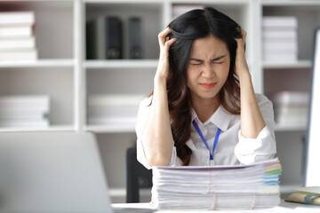 Asian women who are serious about working in the office are stressed by working too hard and missing deadlines.