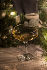 Still life with New Year's background, champagne and sparkling wine are pouring into a festive glass. New Year and Christmas theme