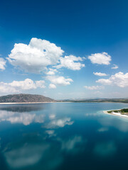 blue sky and clouds, lake mirroring