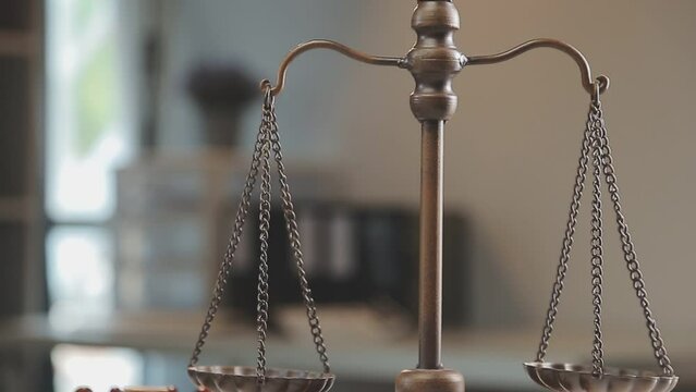 Business and lawyers discussing contract papers with brass scale on desk in office. Law, legal services, advice, justice and law concept picture with film grain effect