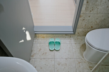 Mint colored bathroom slippers neatly placed