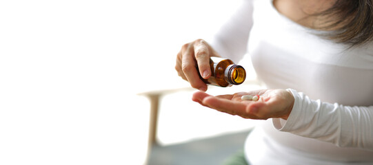 Senior woman at home taking medicine.