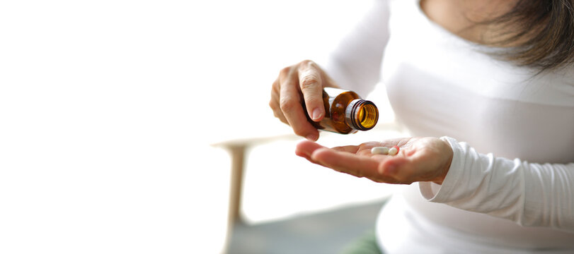 Senior Woman At Home Taking Medicine.