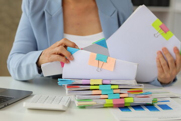 Senior businesswoman is stressed from doing too much paperwork.