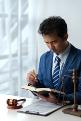 Lawyer, legal advisor, businessman reading and using pen pointing at legal code information...