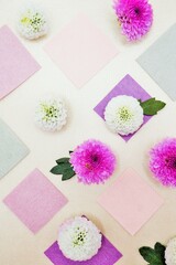 サテンの布背景に白とピンクの丸いピンポンマムという菊の花と和紙を並べたカラフルで可愛い背景素材、縦