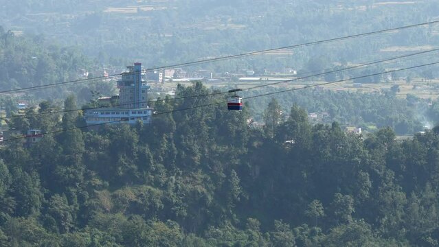 A cable car crossing a deep gorge covered with trees in Kushma, Nepal.