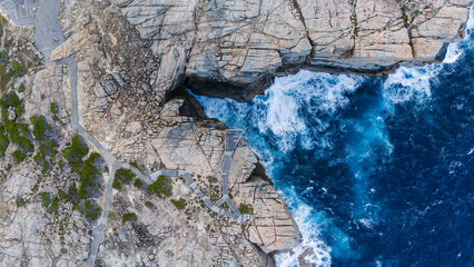 The Gap and Natural Bridge in Albany Western Australia seen from high above with huge waves below