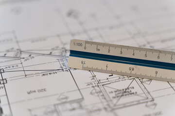 Architectural Scale Ruler with paper blueprints plans for new building