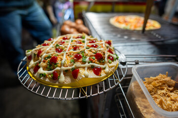 Close up of Banh Trang Nuong Or local vietnam pizza is a popular street food for tourist and people...