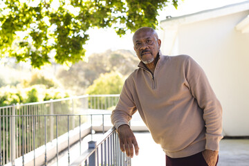 Portrait of african american senior man on sunny terrace