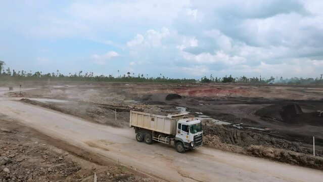 Dump Trucks Driving To The Coal Mine - Coal Surface Mining Site In Berau, Indonesia. - aerial shot