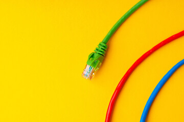Network cable on yellow background studio shot