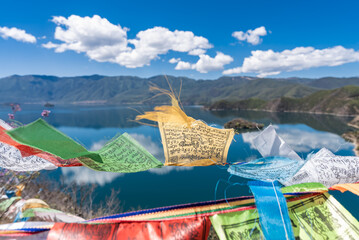 Buddhist prayer flags fluttering next to Lugu Lake in China