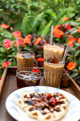 Cold milk coffee cups in Da Lat city, Vietnam style on table. Selective Focus.
